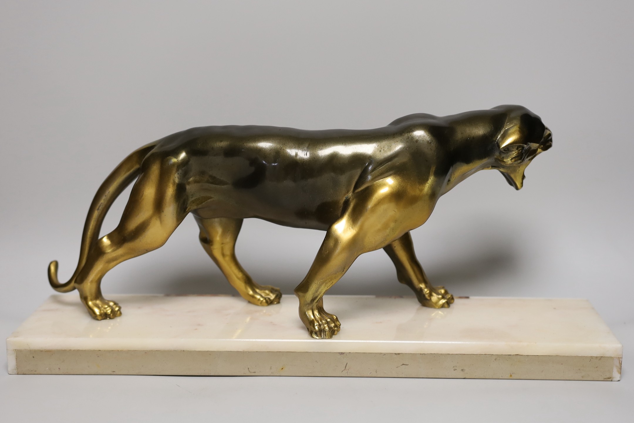 An Art Deco model of a spelter panther on a marble base, 50cms wide in total